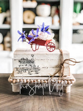 Load image into Gallery viewer, Stamped Book Stack - Wheelbarrow with flowers